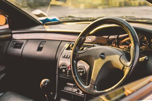 fiat shallow focus photography of car steering wheel windshield